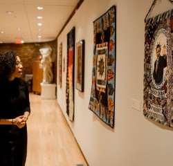 A student enjoying a wall of art in the art museum