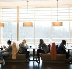 Students having their meals seated in the window seats in the Dining Commons