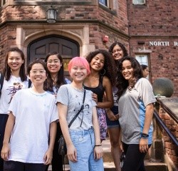 A group of first year students on the steps of North Rockefeller Hall during orientation