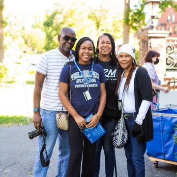 A family of four pose for a photo during move-in day, 2022