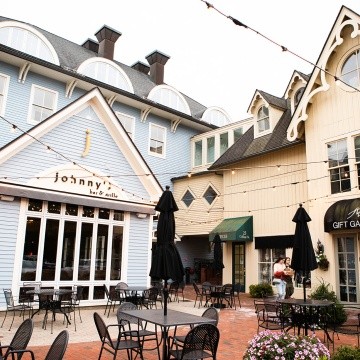 A courtyard by Johnny's Bar & Grille in the Village Commons
