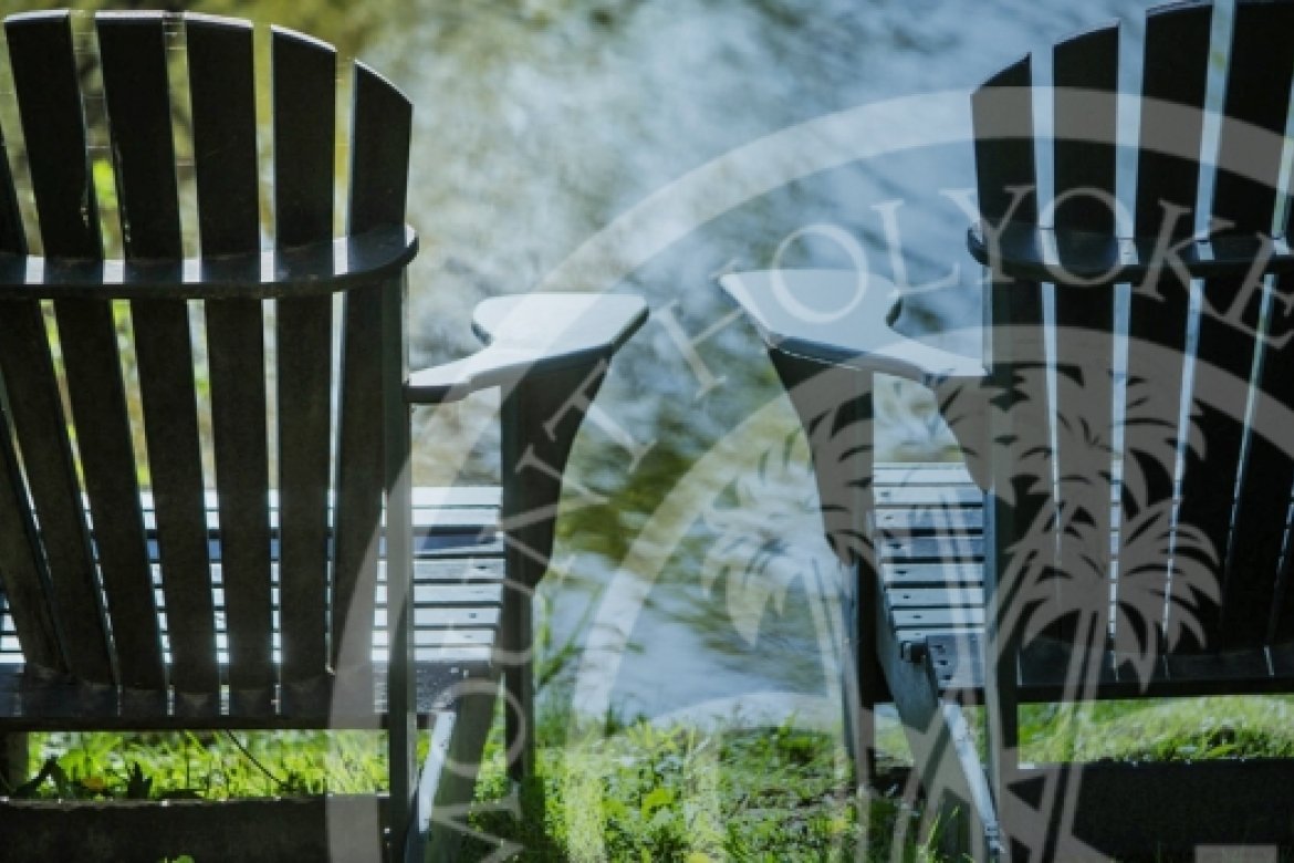 Adirondack chairs at MHC with MHC logo watermarked over it.