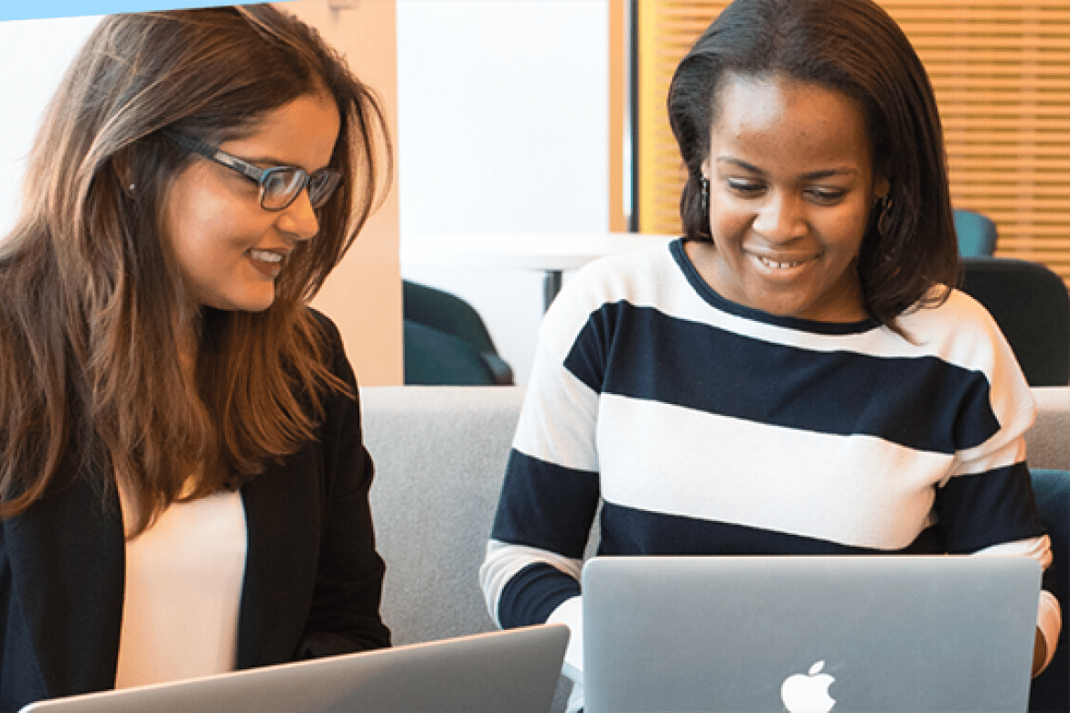 Master's students working together at their laptops