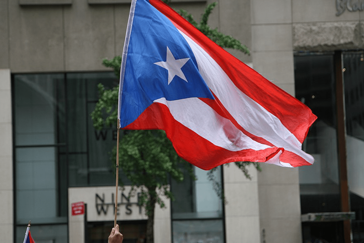 The flag of Puerto Rico being waved in a crowd 