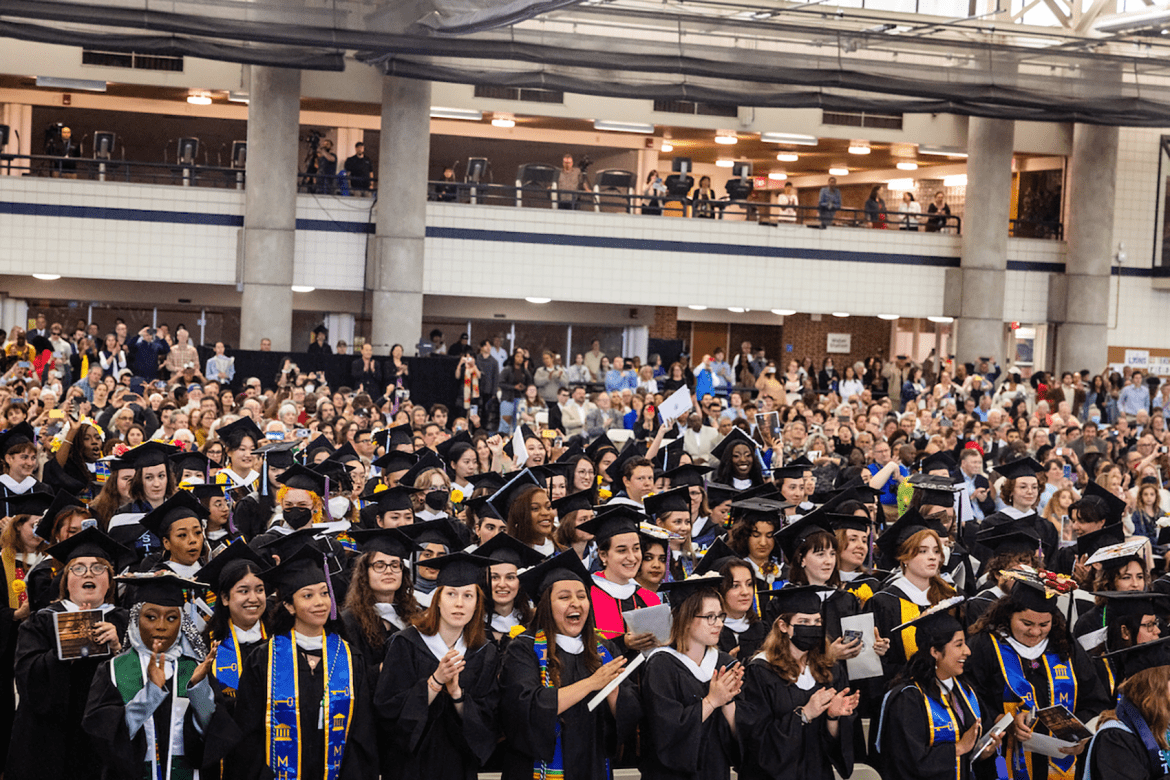 Graduates clapping during Commencement 2023