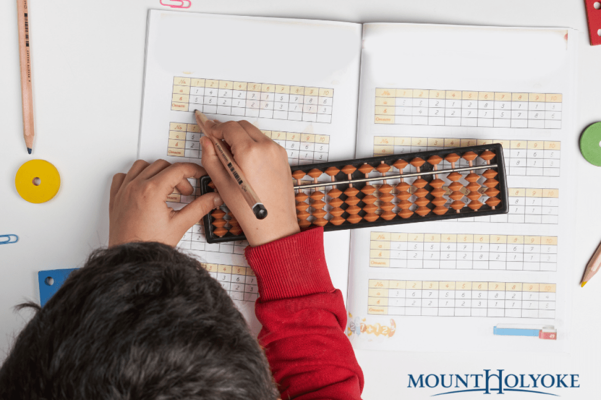 Student doing math with a bead board.