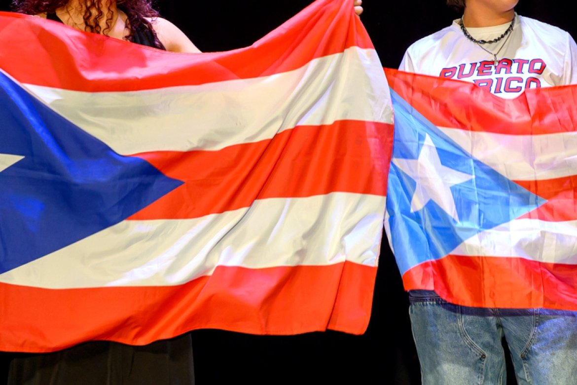 Puerto Rican flags held aloft at the Noche Latina celebration on campus in 2024.