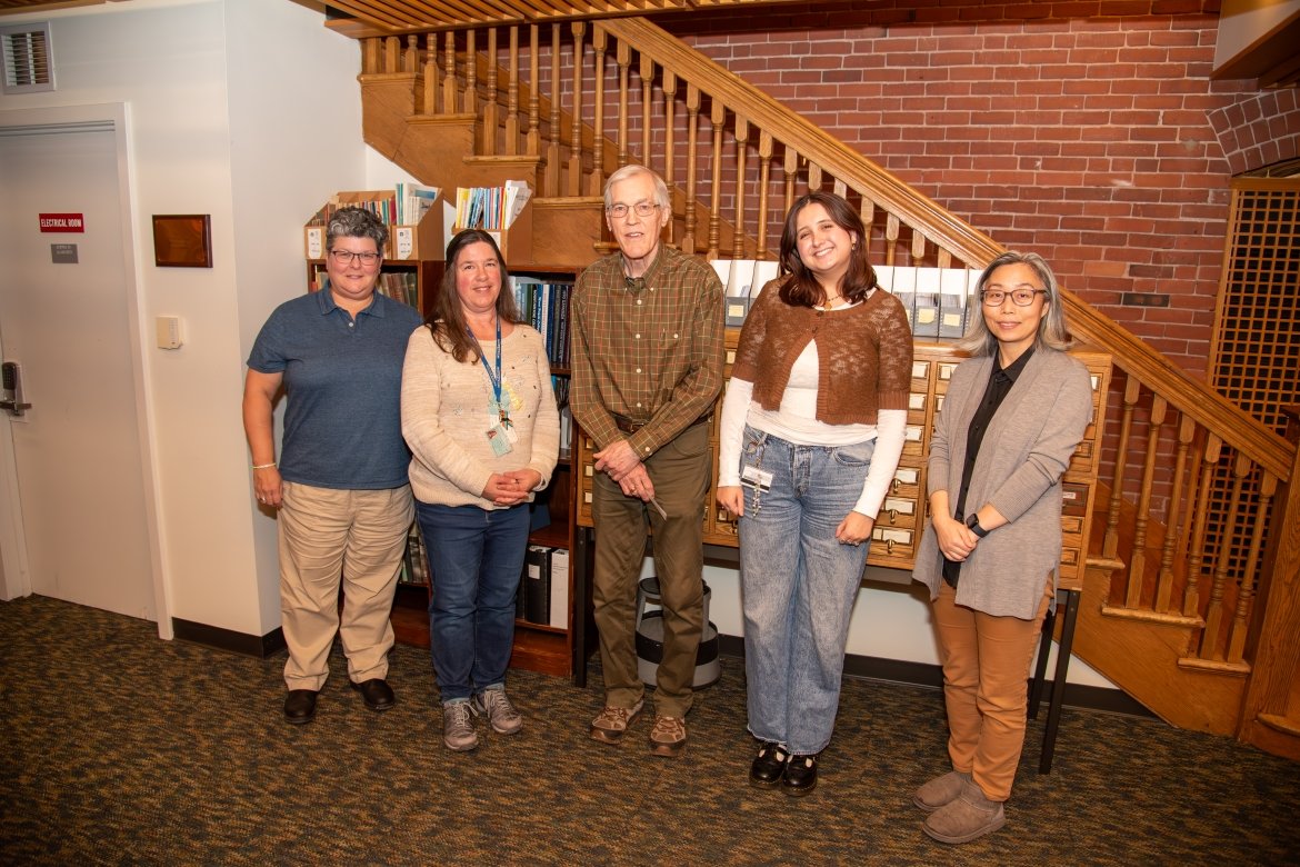 Faculty, staff, and a student pose together for David Crockett Graham archival project.