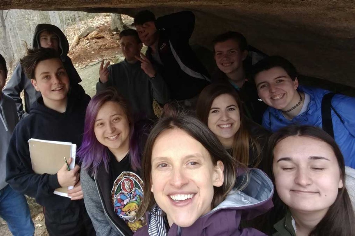 Katharine Hinkle ’02 and her geology students underneath a glacial erratic in Franconia Notch, NH.