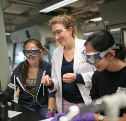 Students working in lab with faculty.