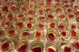 Strawberries in glasses of champagne on a white table