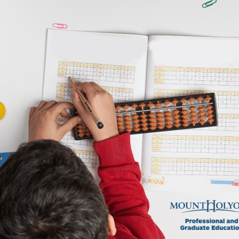 Student doing math with a bead board.