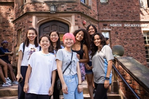 A group of first year students on the steps of North Rockefeller Hall during orientation