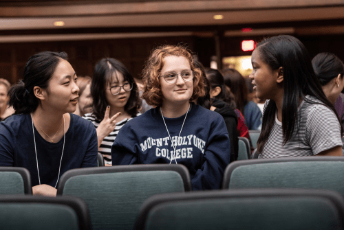 Thee students chatting before an orientation session