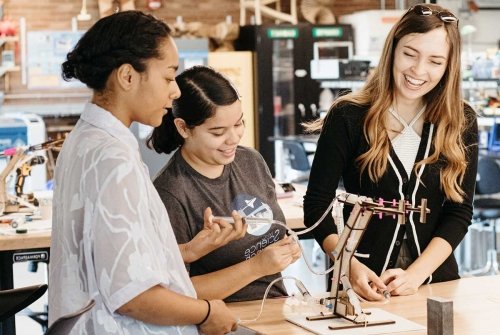 Three students collaborating on a project in the Fimbel Lab