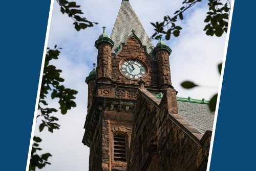 Clock tower on campus with blue slanted bars on either side.