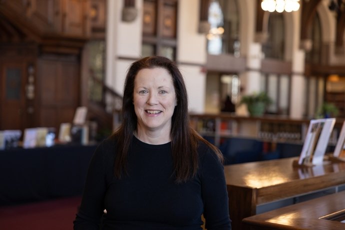 Katie Moran, RN, BSN (pictured in the Mount Holyoke College Reading Room)