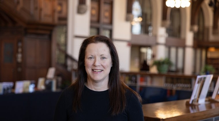 Katie Moran, RN, BSN (pictured in the Mount Holyoke College Reading Room)