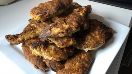 A plate of finished Chicken 65 on a plate waiting to be eaten.