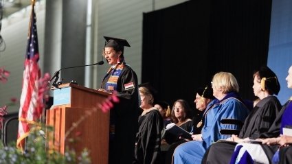 Nada Taha Al Thawr on stage giving the student address.