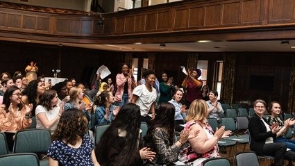 A Mount Holyoke student is cheered as she walks up the aisle to accept her award for leadership.