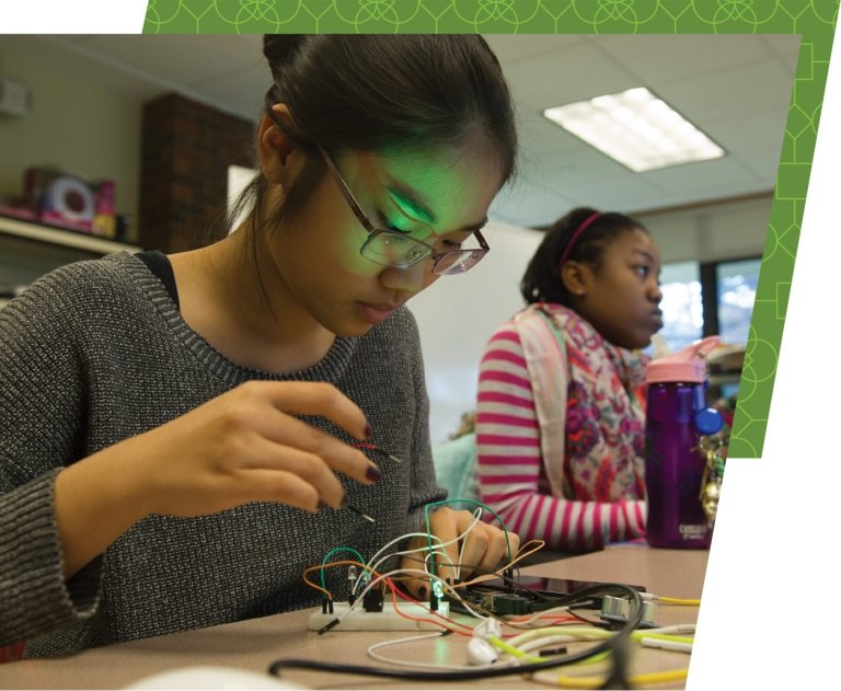 Academic excellence: a student is working on a circuitry board