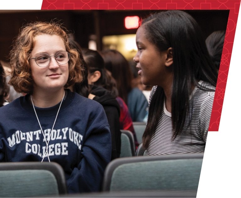 Student experience: two students in a theater smiling at one another